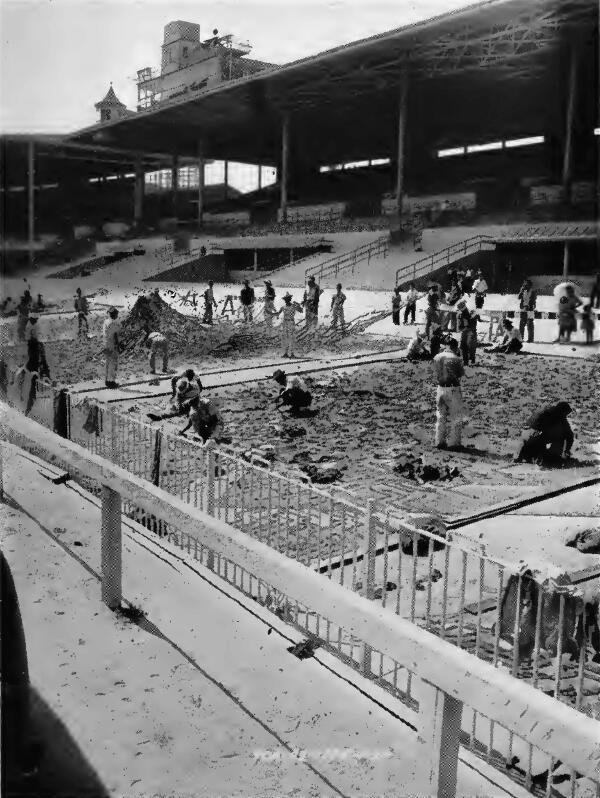 Japanese evacuees in a progressing stage of making camouflage nets at Santa Anita (California) Assembly Center